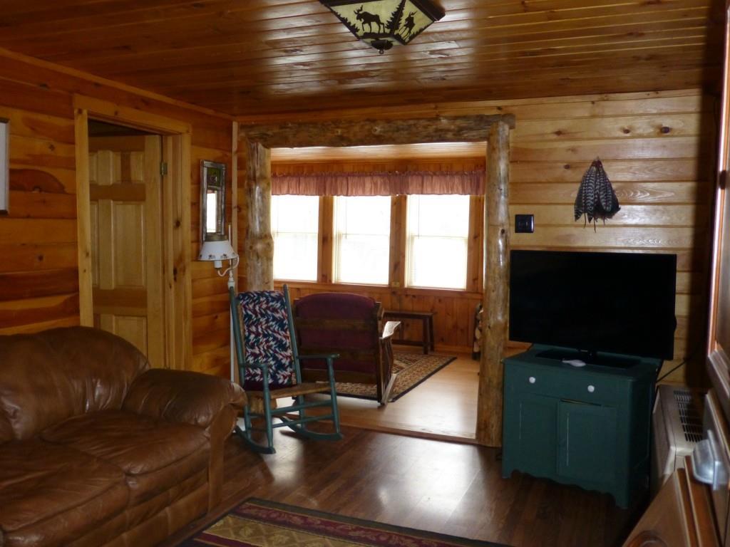 32 Bald Mt Road Oquossoc, ME 04964 - Photo 23 of 35 living area looking into front porch