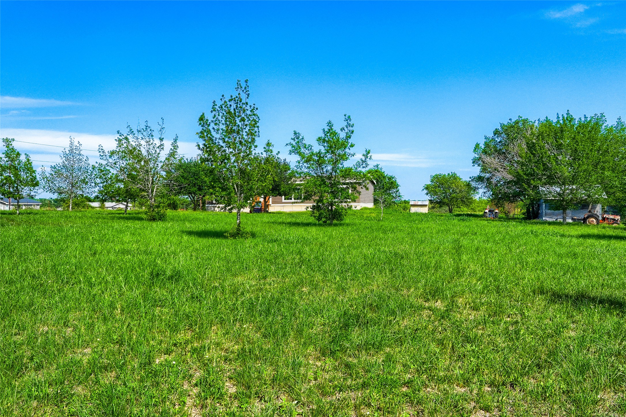 401 Graef Road Kyle, TX 78640 - Photo 27 of 30 A spacious, verdant lot awaits your dream home under an azure sky.