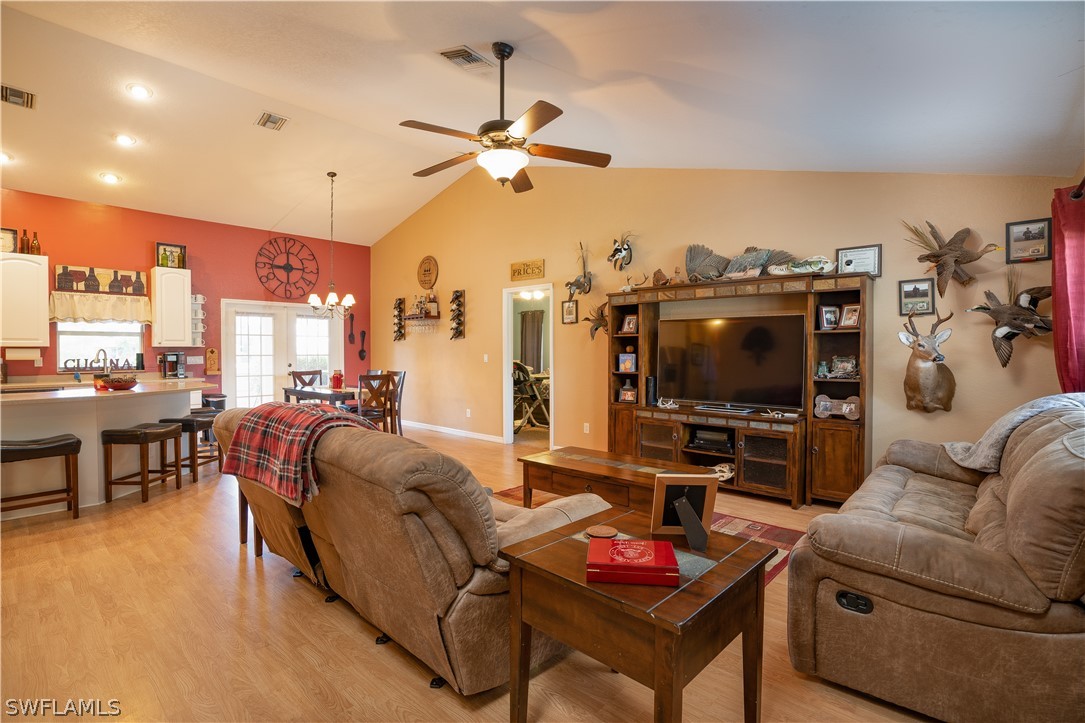 18464 Sunflower Road Fort Myers, FL 33967 - Photo 4 of 30 a living room with furniture and a flat screen tv