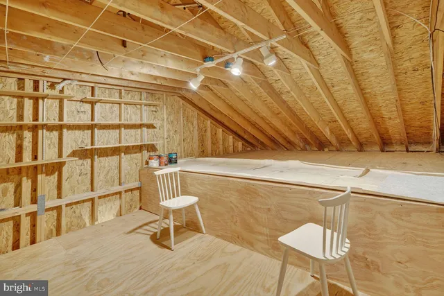 a wooden bench sitting on top of a wooden floor