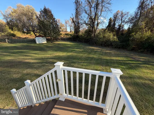 a view of a wooden deck with lake view