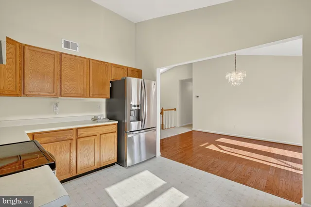 a kitchen with refrigerator cabinets and wooden floor