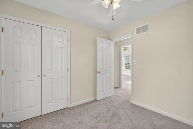 an empty room with a ceiling fan