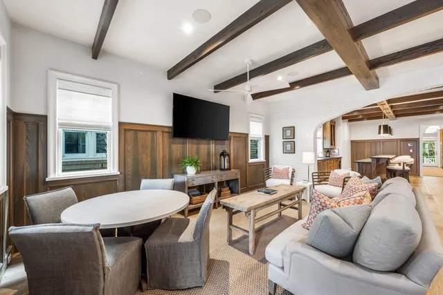 a living room with furniture and wall paintings