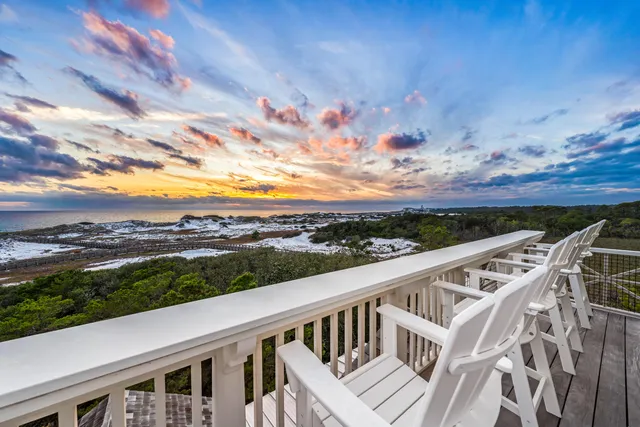 a view of a patio with couches table and chairs and potted plants