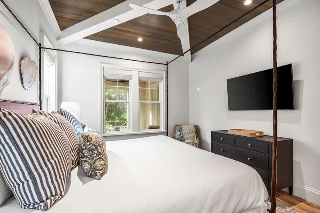 a bedroom with a bed and a flat screen tv