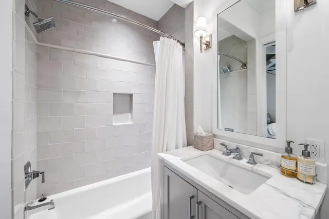 a bathroom with a granite countertop sink mirror and double