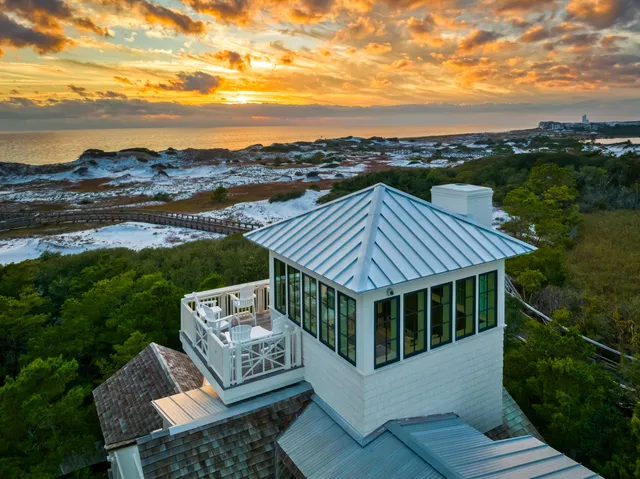 a backyard of a house with garden and outdoor seating