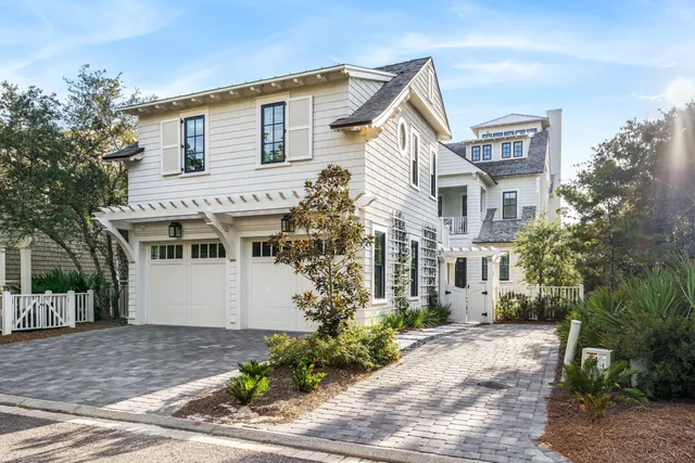 a kitchen with stainless steel appliances granite countertop a table chairs and a refrigerator