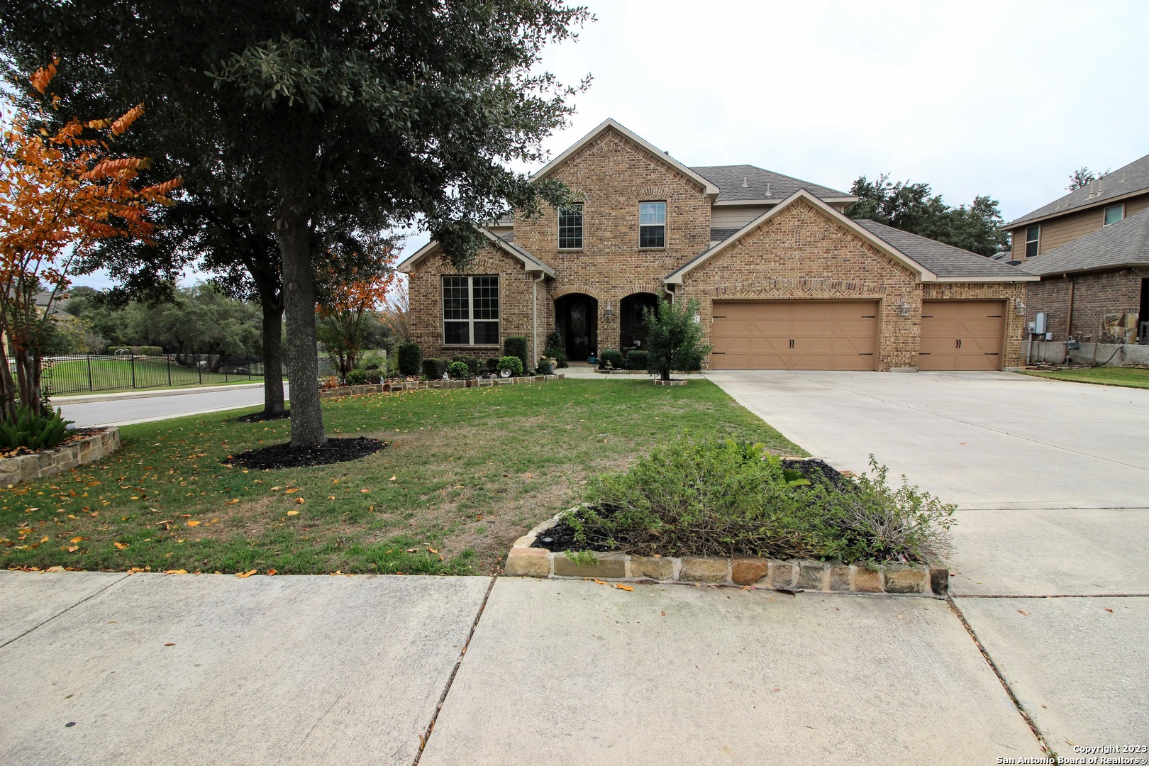 8902 River Trace San Antonio, TX 78255 - Photo 1 of 1 a front view of a house with a yard and garage