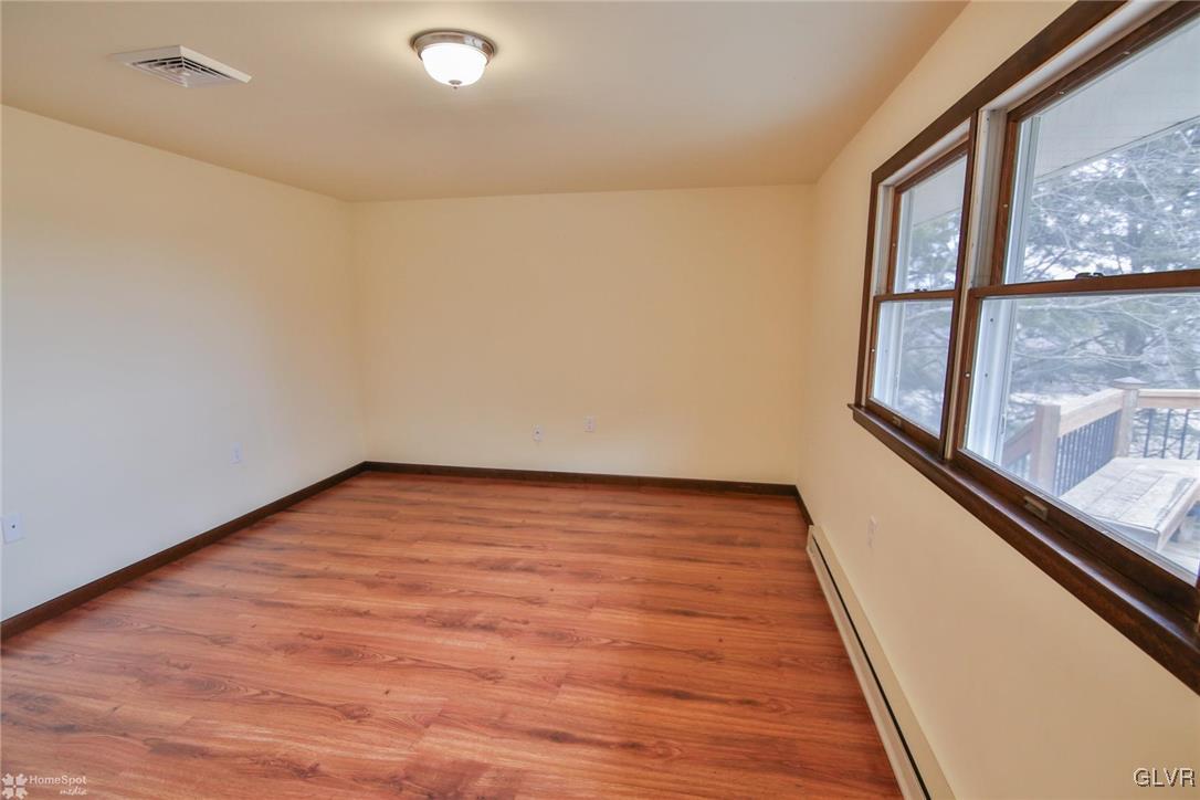 437 Hahn Road Nazareth, PA 18064 - Photo 11 of 38 a view of an empty room with wooden floor and a window