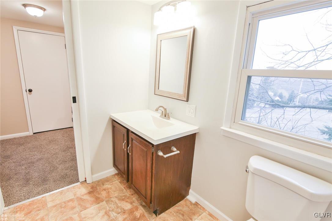 437 Hahn Road Nazareth, PA 18064 - Photo 16 of 38 a utility room with a sink a toilet and a mirror