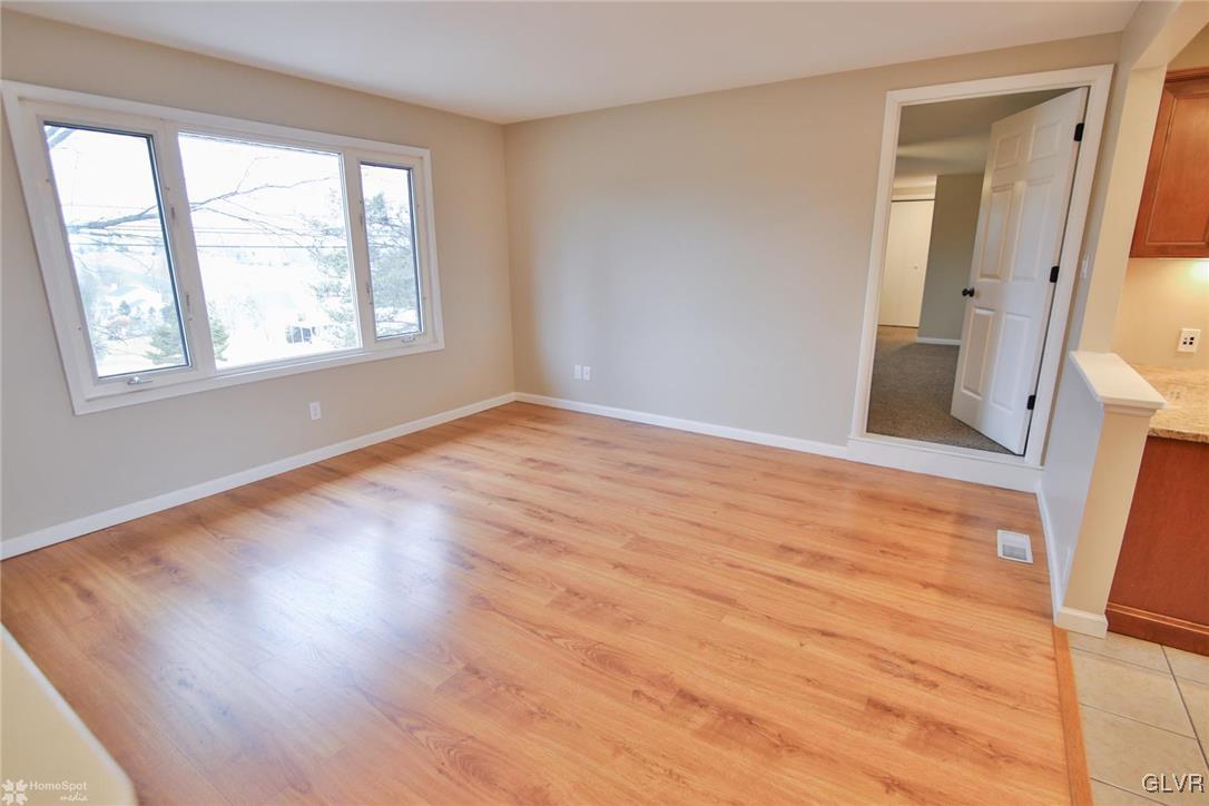 437 Hahn Road Nazareth, PA 18064 - Photo 5 of 38 a view of an empty room with wooden floor and a window