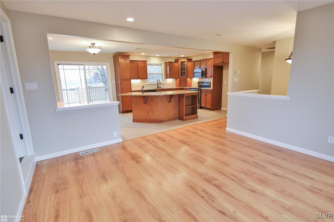 437 Hahn Road Nazareth, PA 18064 - Photo 6 of 38 a large kitchen with stainless steel appliances wooden floors and large window
