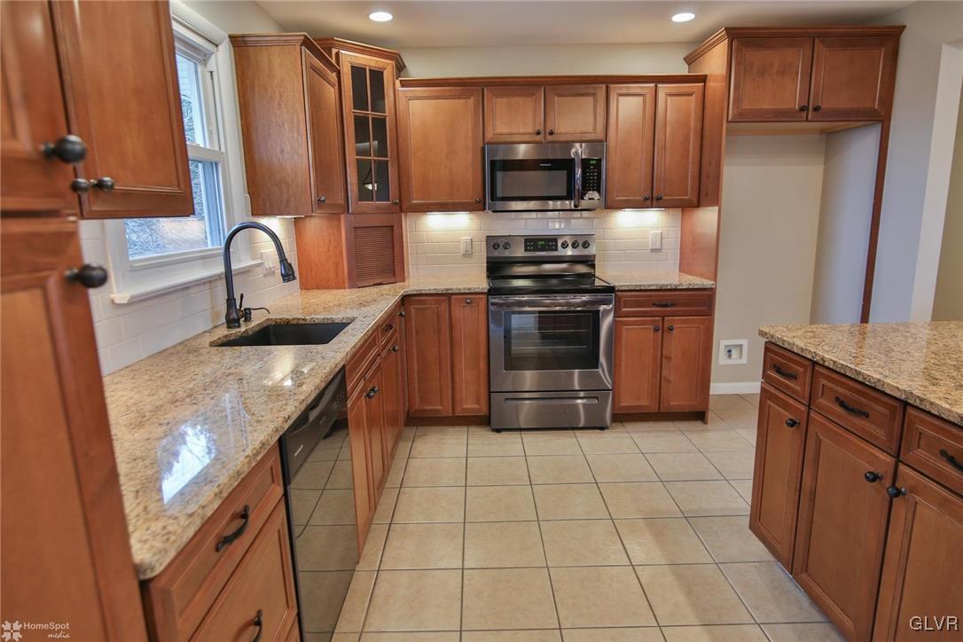 437 Hahn Road Nazareth, PA 18064 - Photo 7 of 38 a kitchen with stainless steel appliances granite countertop a sink stove and refrigerator