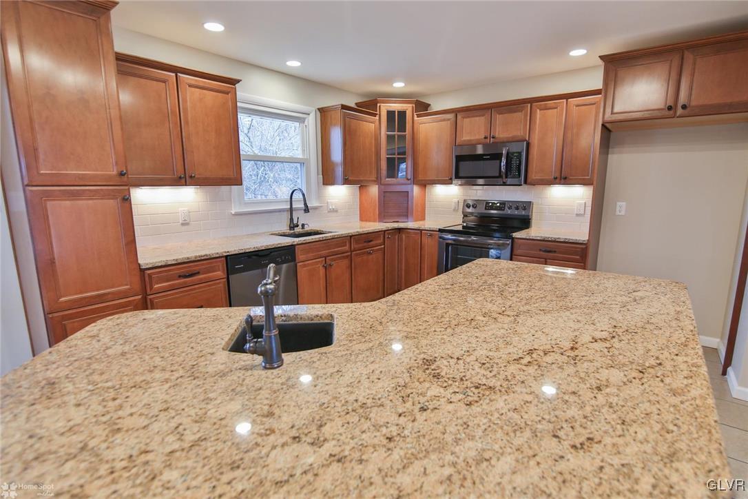 437 Hahn Road Nazareth, PA 18064 - Photo 9 of 38 a kitchen with stainless steel appliances granite countertop a refrigerator sink and cabinets
