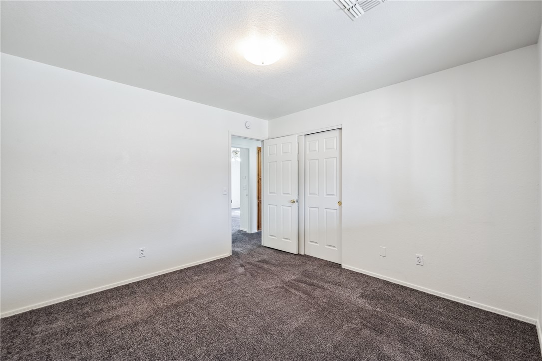 2524 South Ridge Avenue Bullhead City, AZ 86429 - Photo 38 of 64 Empty room featuring dark carpet and baseboards