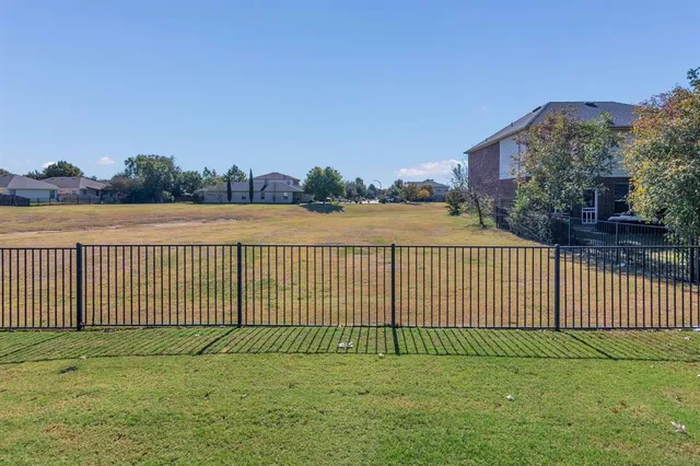 a view of a fence and a yard