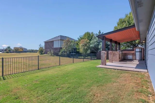 a view of a backyard with a garden and fire pit