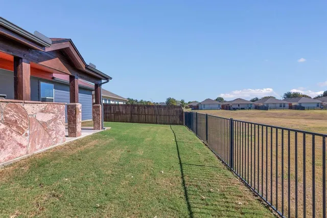 a balcony view with a backyard
