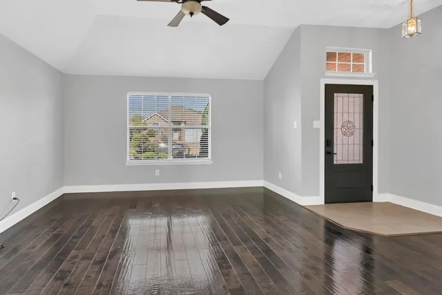 wooden floor in an empty room with a window
