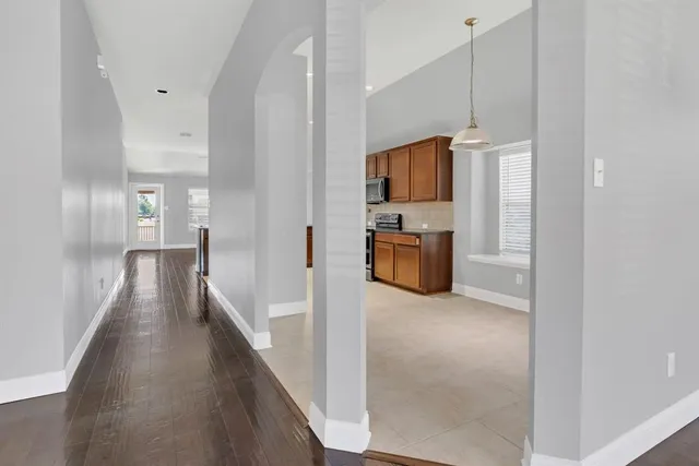 a view of a living room with kitchen
