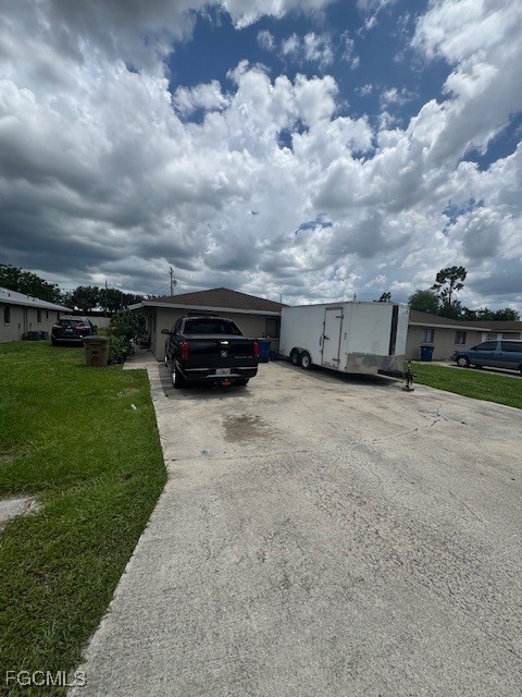 13861 First Street, Unit 13863 Fort Myers, FL 33905 - Photo 11 of 11 a view of a car in front of a house with a yard