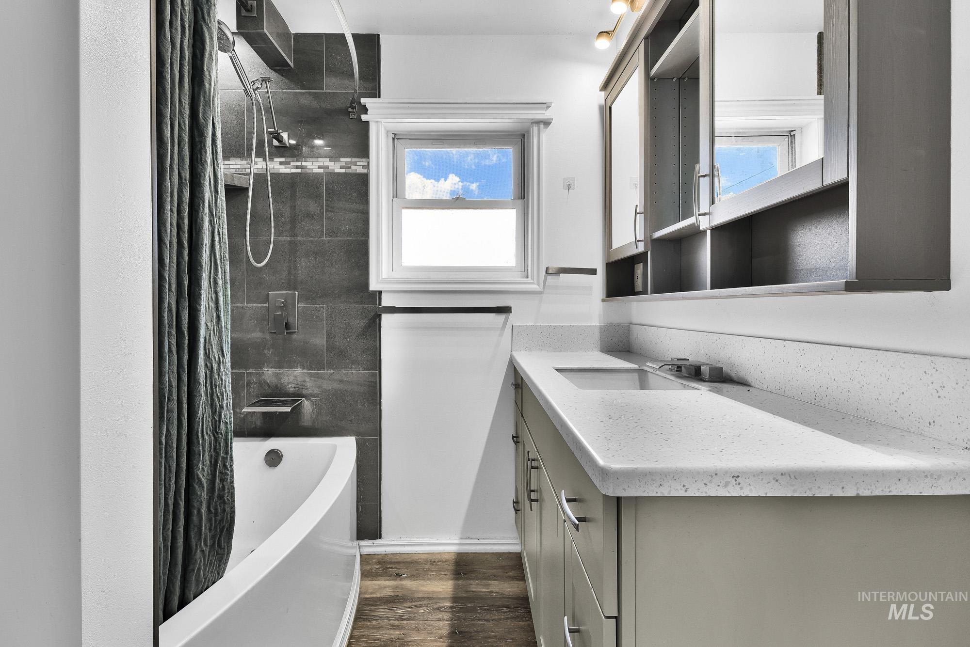 24900 Market Road Parma, ID 83660 - Photo 47 of 50 Bathroom featuring a spacious vanity with an undermount sink and light-toned solid surface countertop