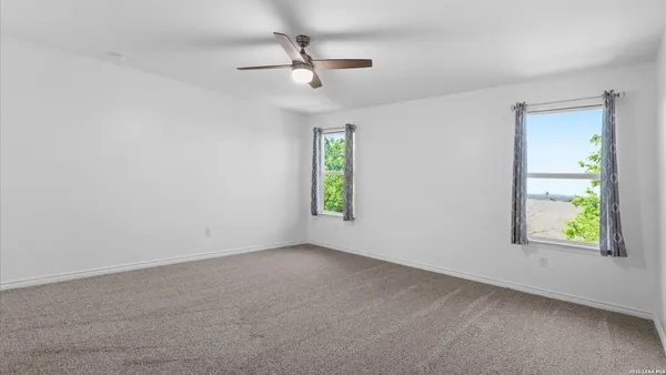 an empty room with windows and closet