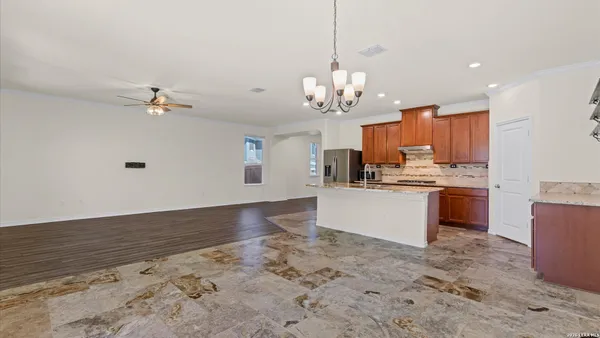 a view of kitchen with sink microwave and cabinets