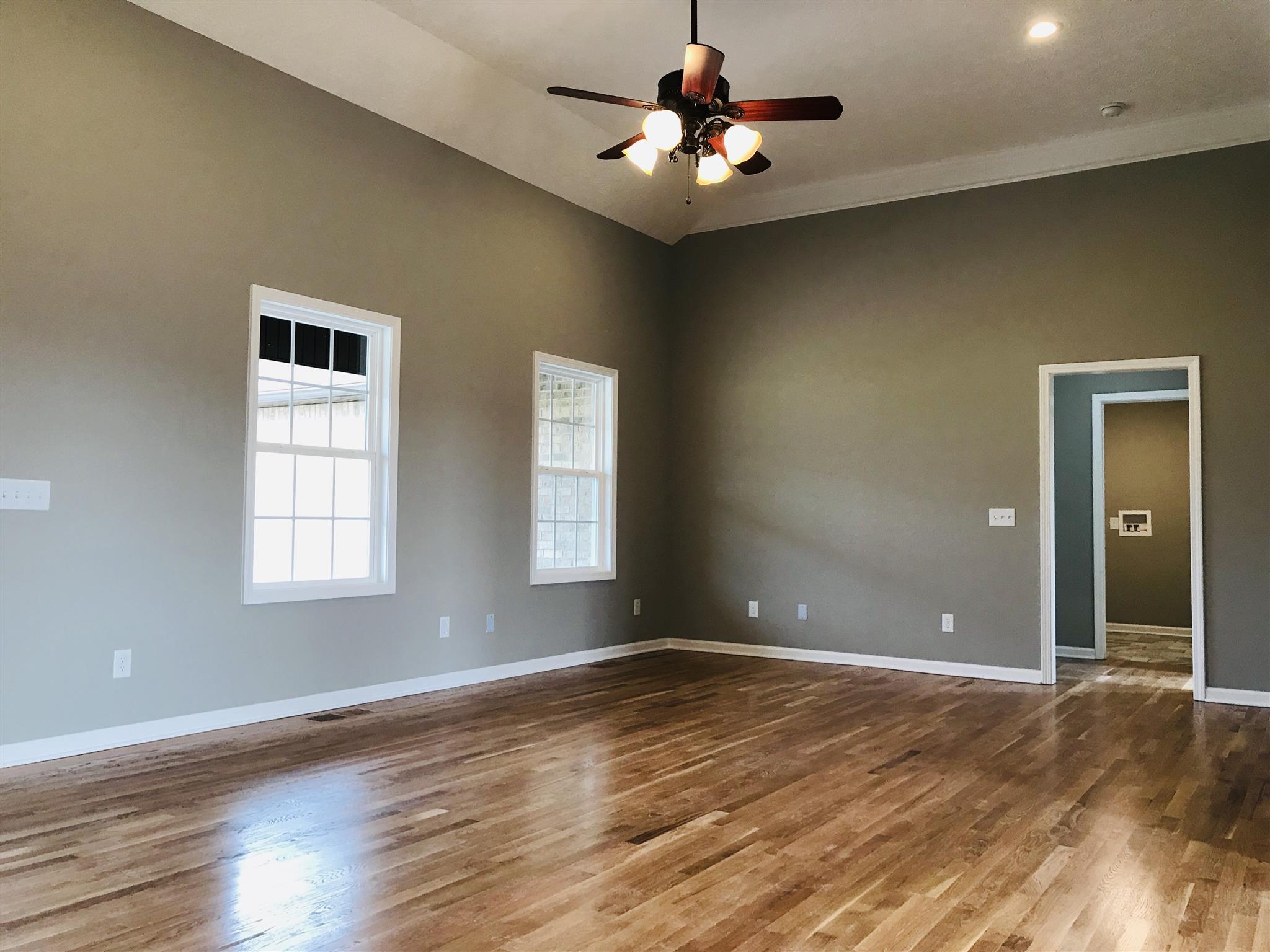 412 Fowler Ford Road Portland, TN 37148 - Photo 2 of 16 a view of an empty room with window and wooden floor