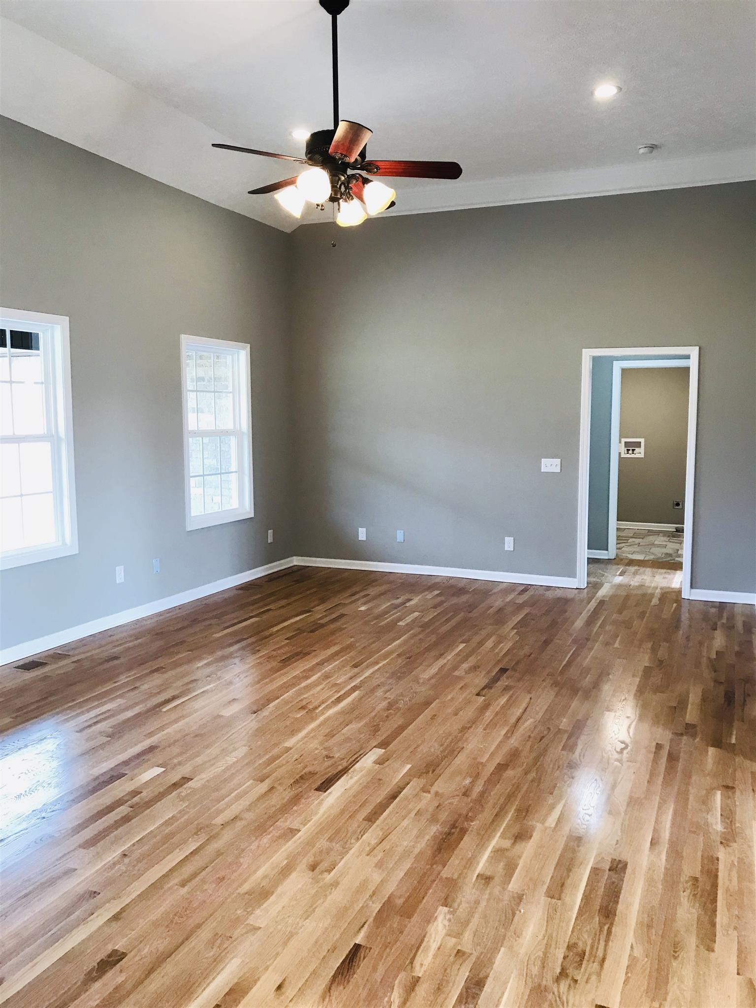 412 Fowler Ford Road Portland, TN 37148 - Photo 3 of 16 wooden floor in an empty room with a window