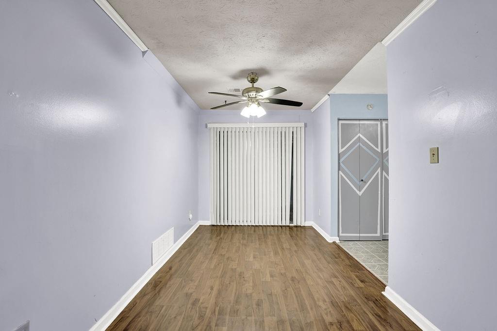 5012 Galbraith Circle Stone Mountain, GA 30088 - Photo 11 of 29 wooden floor in an empty room with a window