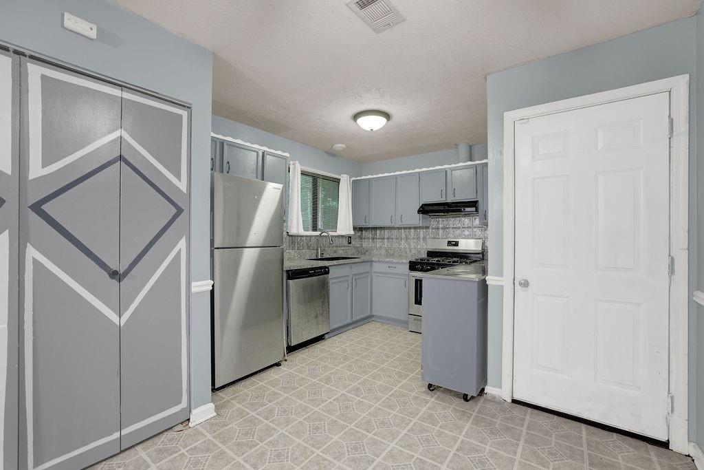 5012 Galbraith Circle Stone Mountain, GA 30088 - Photo 13 of 29 a kitchen with a refrigerator sink and stove top oven