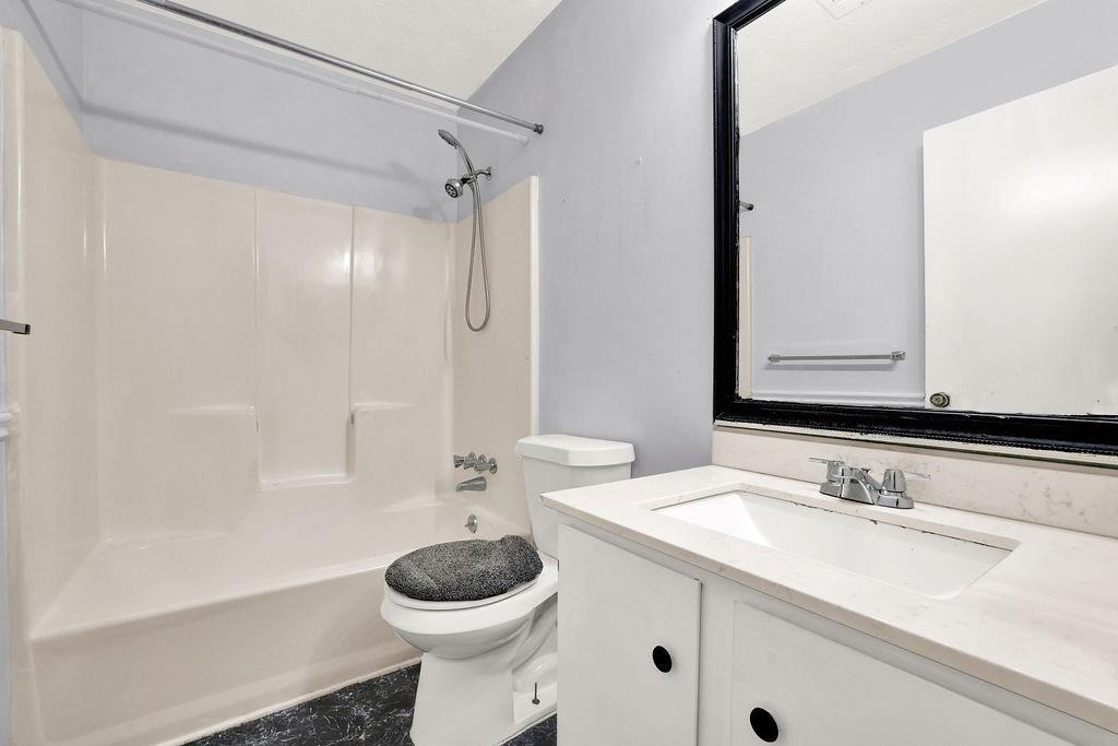 5012 Galbraith Circle Stone Mountain, GA 30088 - Photo 17 of 29 a bathroom with a sink toilet a mirror and shower