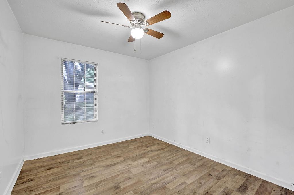 5012 Galbraith Circle Stone Mountain, GA 30088 - Photo 18 of 29 an empty room with a window and a ceiling fan