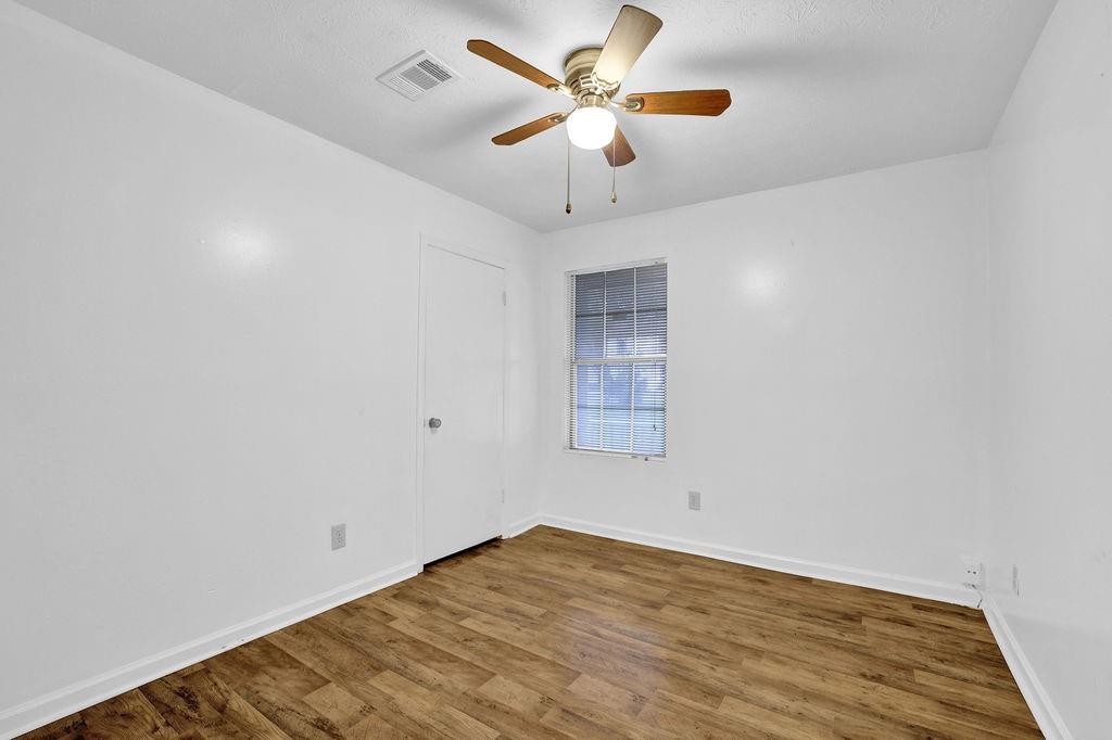 5012 Galbraith Circle Stone Mountain, GA 30088 - Photo 20 of 29 wooden floor in an empty room with a window