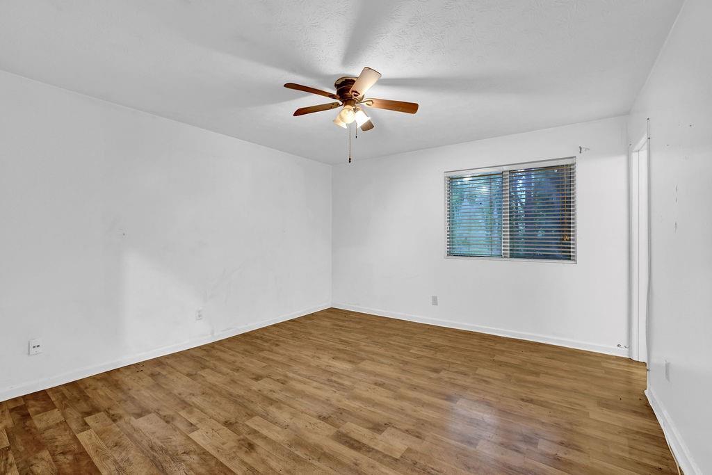 5012 Galbraith Circle Stone Mountain, GA 30088 - Photo 21 of 29 wooden floor in an empty room with a window