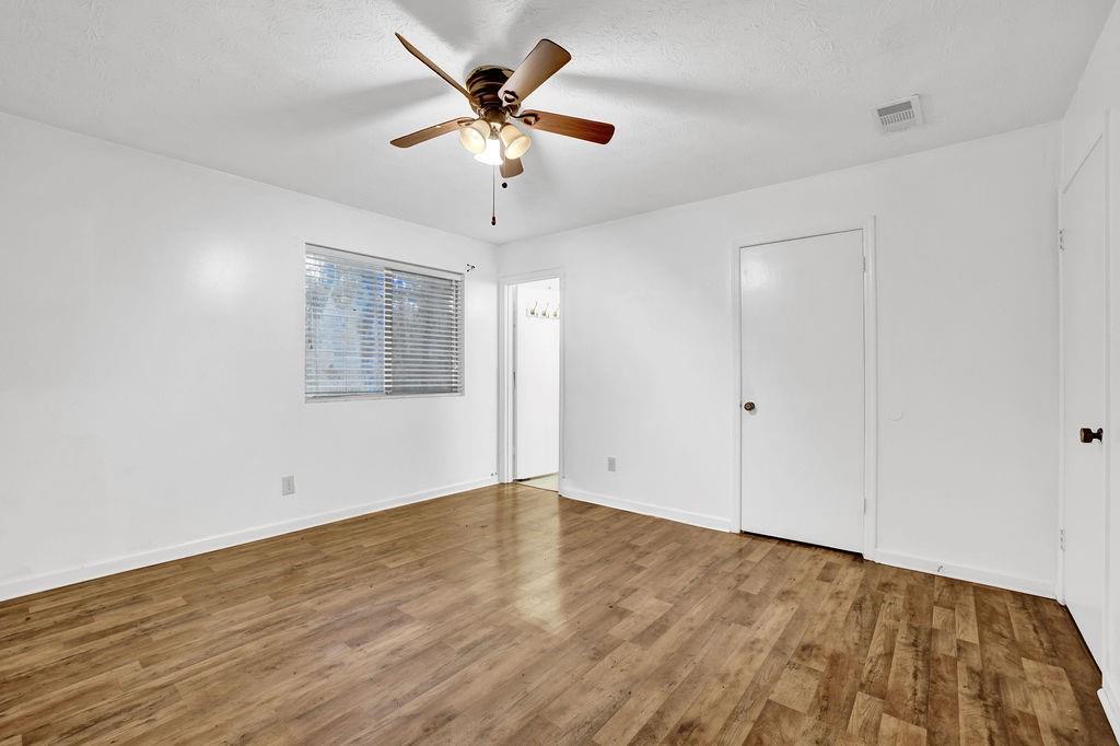 5012 Galbraith Circle Stone Mountain, GA 30088 - Photo 23 of 29 an empty room with wooden floor and windows