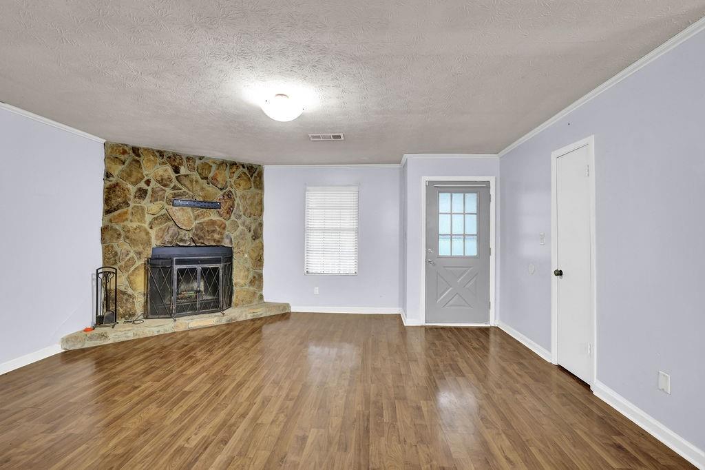 5012 Galbraith Circle Stone Mountain, GA 30088 - Photo 7 of 29 wooden floor fireplace and natural light in room