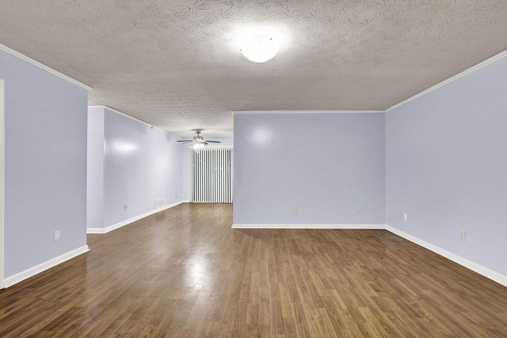 5012 Galbraith Circle Stone Mountain, GA 30088 - Photo 10 of 29 a view of an empty room with wooden floor