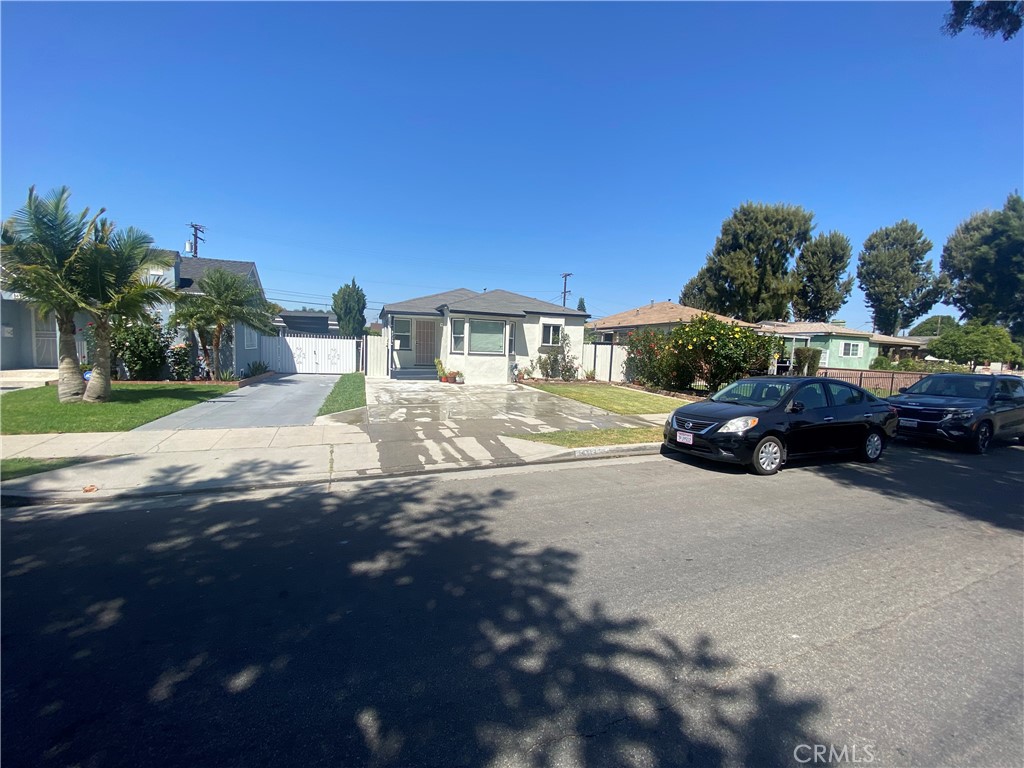 14713 South Castlegate Avenue Compton, CA 90221 - Photo 2 of 4 a street view with couple of cars parked on road