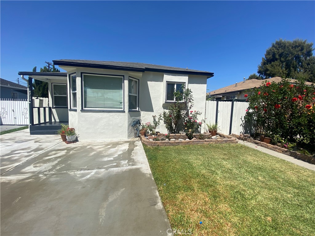 14713 South Castlegate Avenue Compton, CA 90221 - Photo 4 of 4 a front view of a house with garden