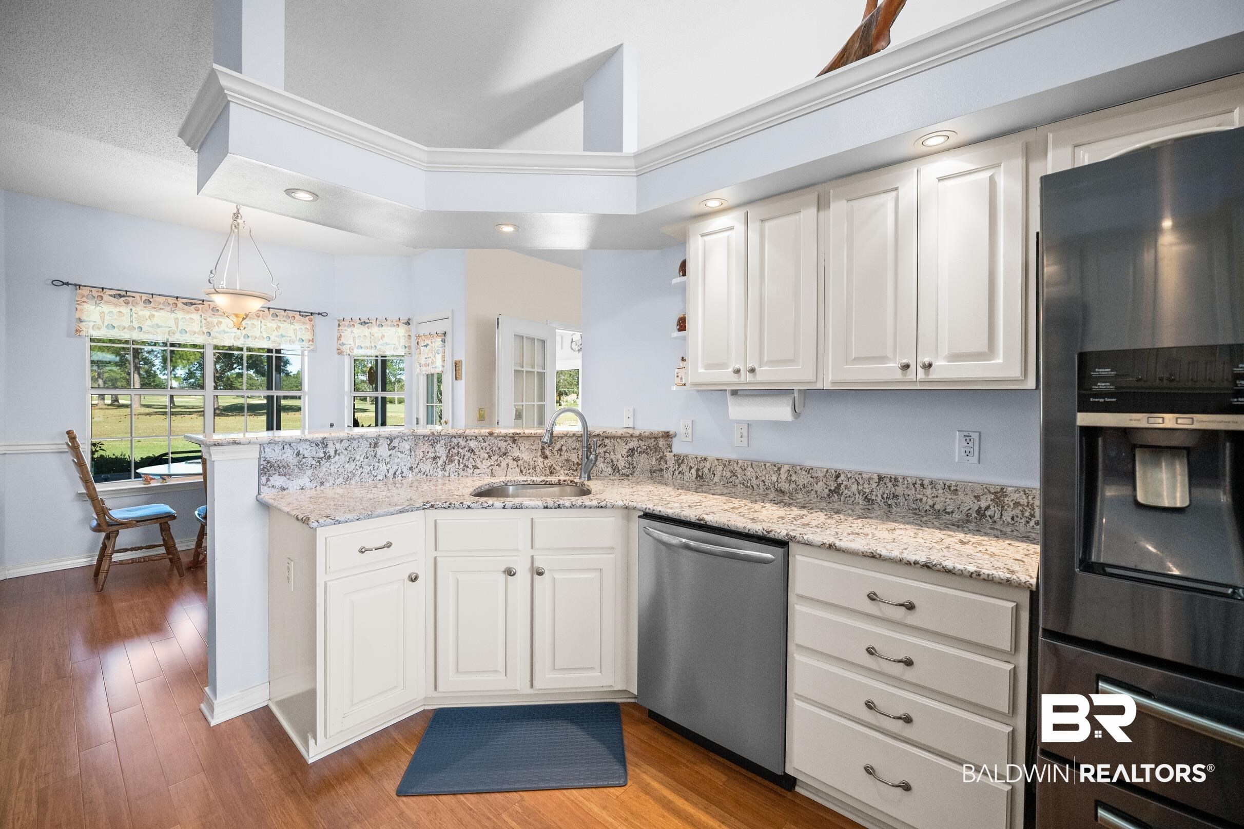 22355 East County Road 12 Foley, AL 36535 - Photo 18 of 54 Kitchen featuring black fridge, white cabinetry, light stone countertops, recessed lighting, and a peninsula