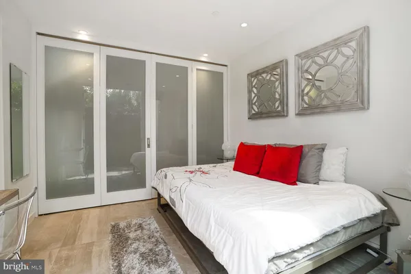 a bedroom with a large bed and a flat screen tv