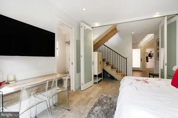 a view of entryway with wooden floor and stairs