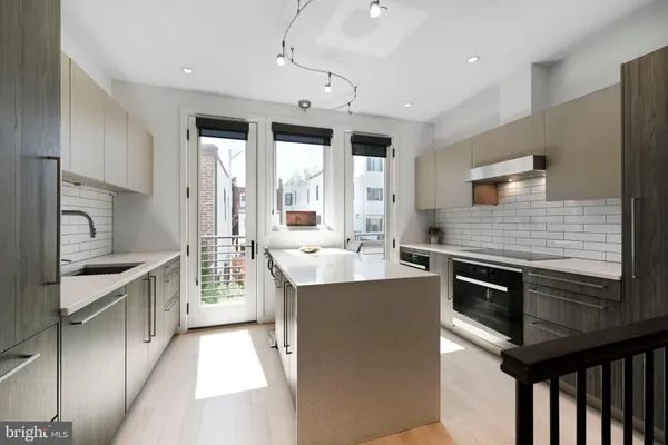 a kitchen with a sink and a refrigerator