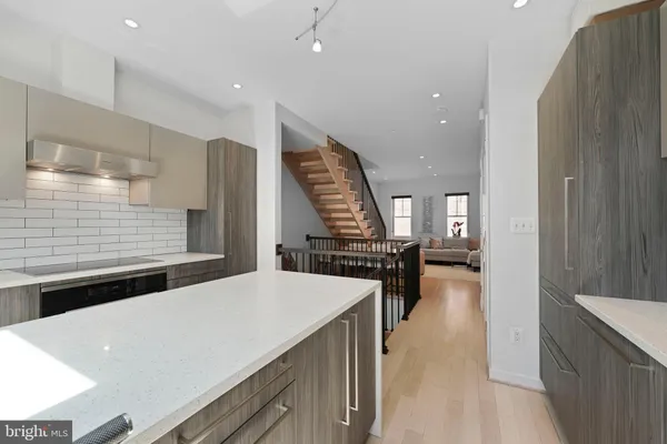 a living room with furniture and stairs