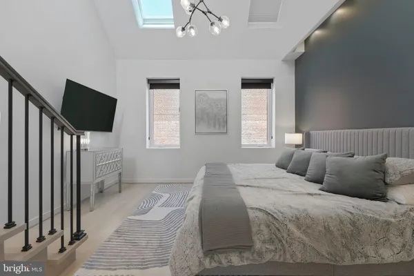 a bedroom with a bed and a chair