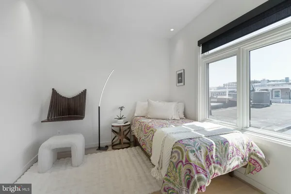 a bedroom with furniture and a large window